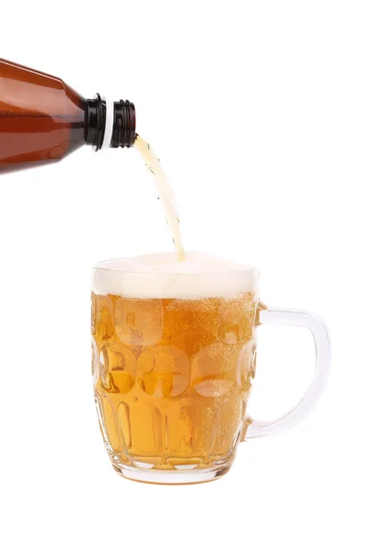 Bottle of beer pouring into a mug. — Stock Photo, Image