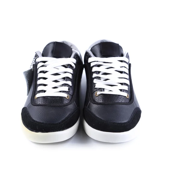 Zwarte sneakers met witte veters. — Stockfoto