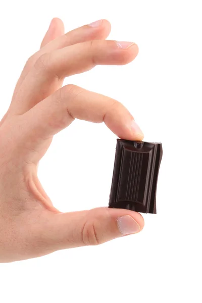Hand hält zwei Stücke Schokolade. — Stockfoto