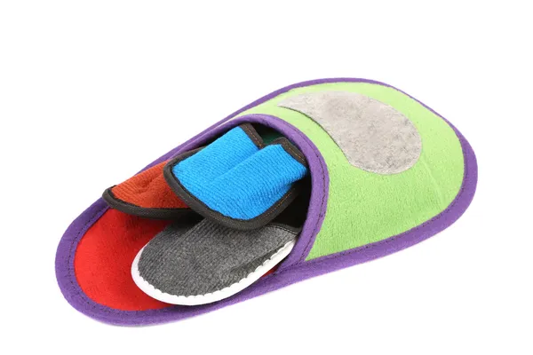 Four small slippers inside a big. — Stock Photo, Image