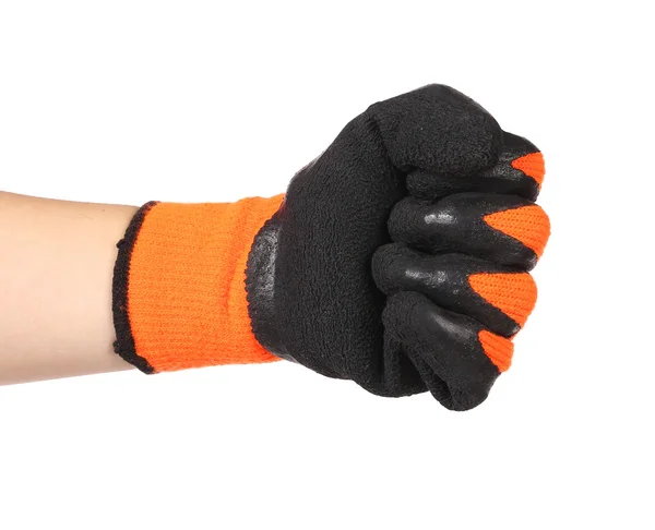 Hand toont vuist in een zwart en oranje rubberen handschoen — Stockfoto