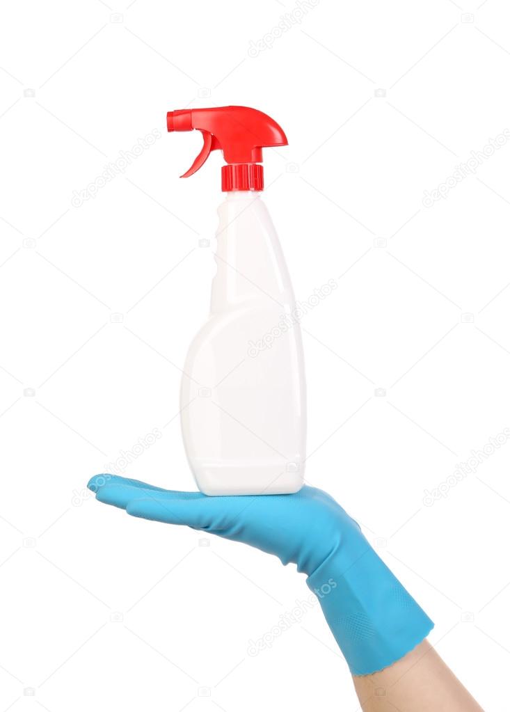 Hand in glove holding white plastic spray bottle