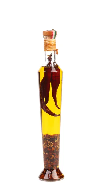 Red chillies preserved in bottle of olive oil. — Stock Photo, Image