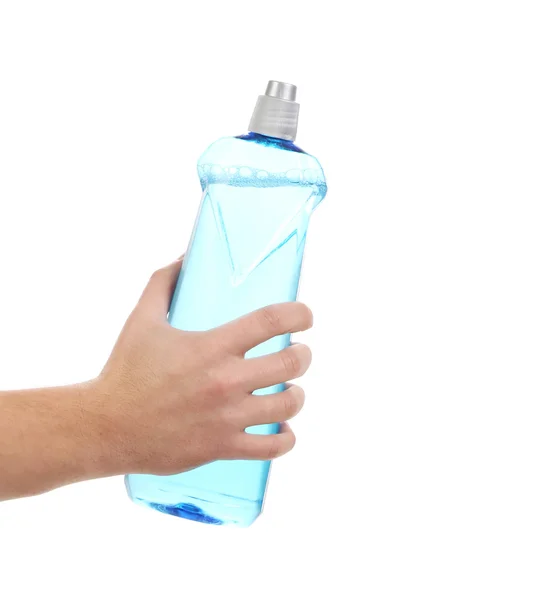 Hand in Handschuhen hält Waschmittelflasche. — Stockfoto