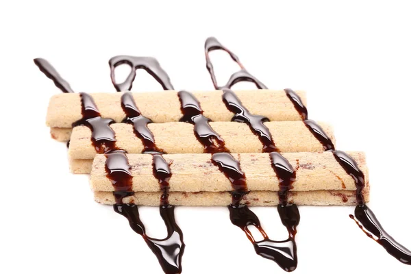 Chocolate stream on stics of biscuit. — Stock Photo, Image