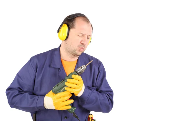 Worker in ear muffs with drill — Stock Photo, Image