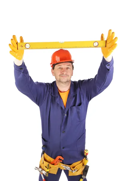 Worker in hard hat raising ruler — Stock Photo, Image