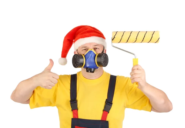 Arbetaren i gasmask och santa hatt med rollern — Stockfoto