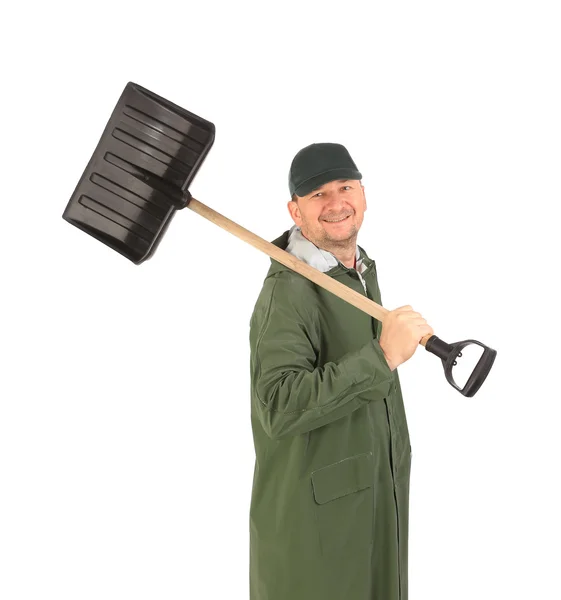 Man in long vest with shovel. — Stockfoto