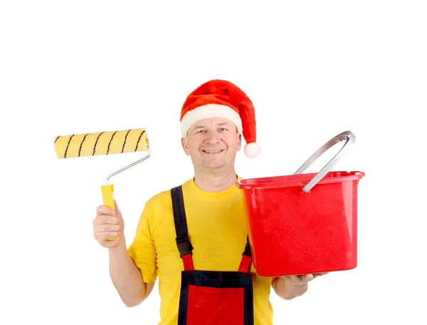 Arbeiter mit Weihnachtsmannmütze und Eimer. — Stockfoto