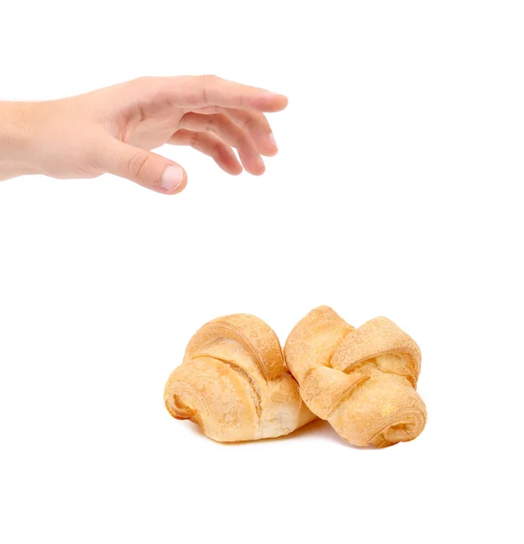 Croissant or crescent roll with hand. — Stock Photo, Image