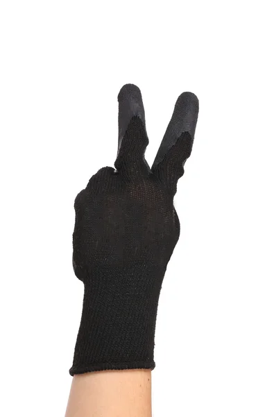 Ruce v rukavicích ukazuje znamení míru. — Stock fotografie