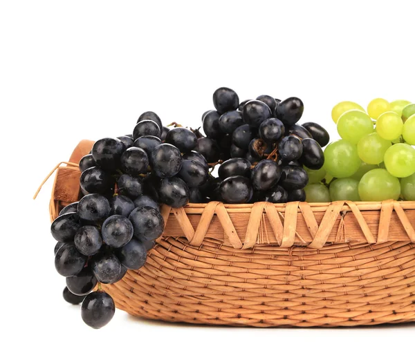 Black and green grapes in basket. — Stock Photo, Image