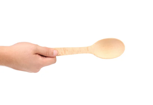 Hand holds wooden spoon — Stock Photo, Image