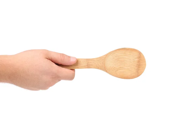 Hand holds wooden spoon — Stock Photo, Image