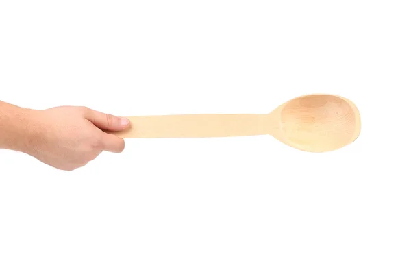 Hand holds wooden spoon — Stock Photo, Image