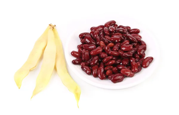 Yellow pods and red beans — Stock Photo, Image