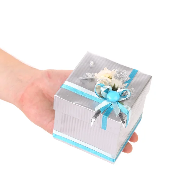 Hand holding gift in white and blue package Royalty Free Stock Photos