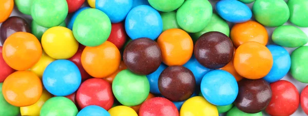 Backgroynd choklad bollar i färgglada glasyr. — Stockfoto