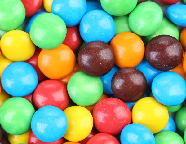 Backgroynd of chocolate balls in colorful glaze. — Stock Photo, Image