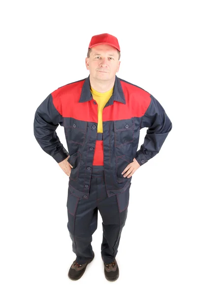 Trabajador en ropa de trabajo y gorra roja . — Foto de Stock