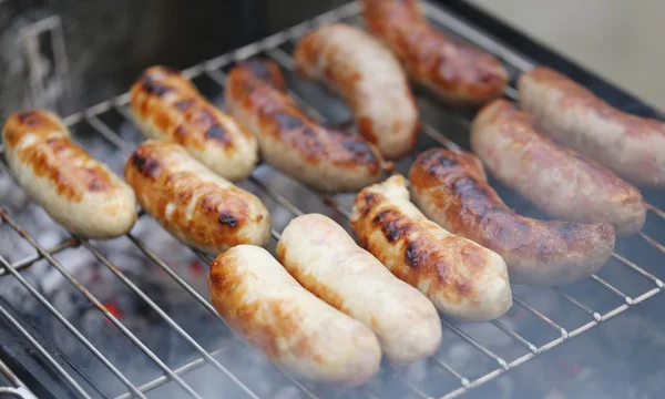 Baking bratwurst sausages on grill. — Stock Photo, Image