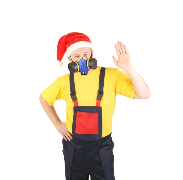 Arbetaren i gasmask och santa hatt säga hej. — Stockfoto