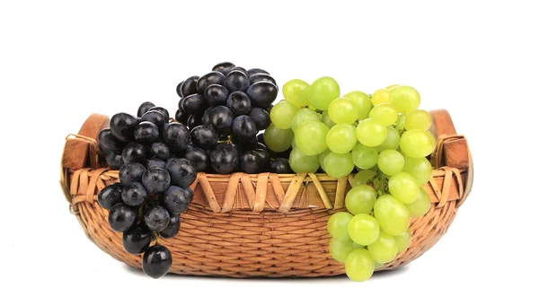 Black and green grapes in basket. — Stock Photo, Image