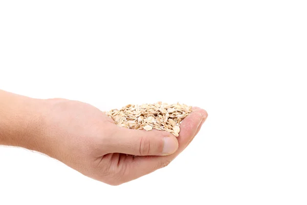 Oatmeal flakes into hand. — Stock Photo, Image