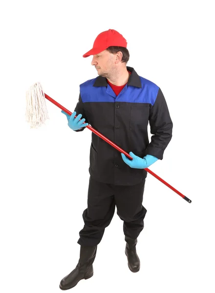 Man in workwear with mop — Stockfoto