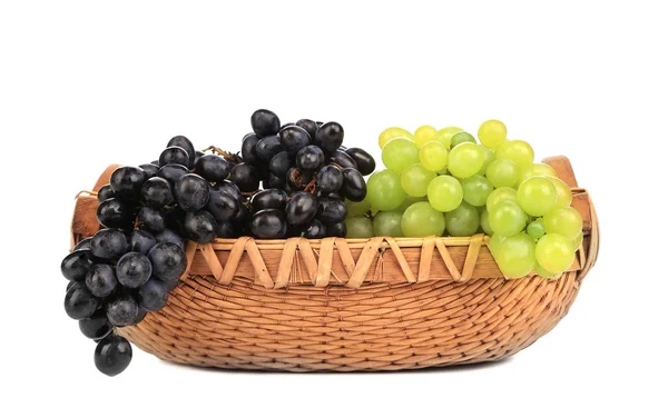 Greenand black grapes in basket. — Stock Photo, Image