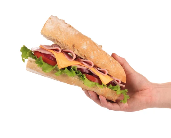 Hand holds french baguette sandwich. — Stock Photo, Image