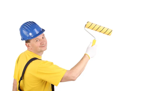 Worker in hardhat paints — Stock Photo, Image