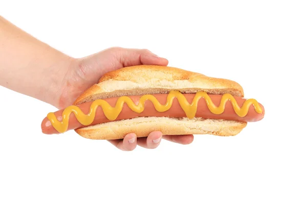 Hotdog met mosterd in hand. — Stockfoto