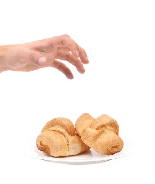 Croissant è preso a mano . — Foto Stock