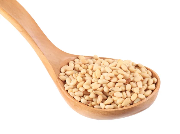 Wooden spoon full with pine nuts. — Stock Photo, Image