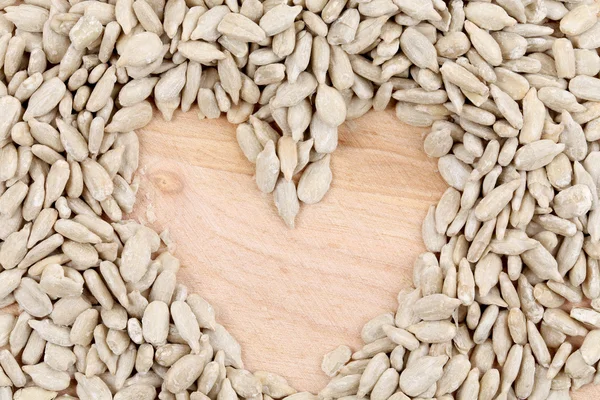 Heart made of seeds on table. — Stock Photo, Image