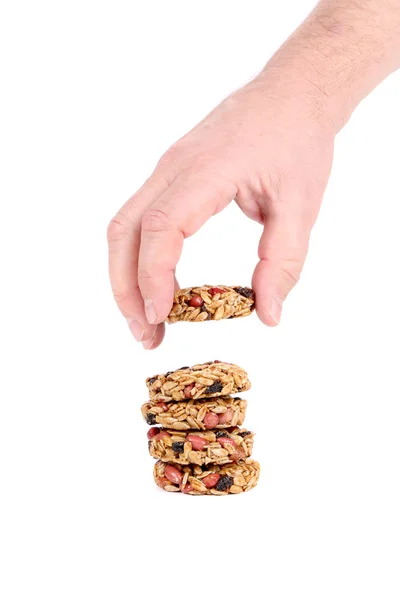 Round candied seeds and nuts in hand. — Stock Photo, Image