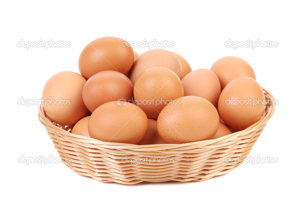 Brown eggs in the basket on a white.
