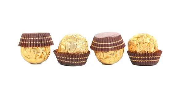 Vier in rij chocolade bonbons. — Stockfoto