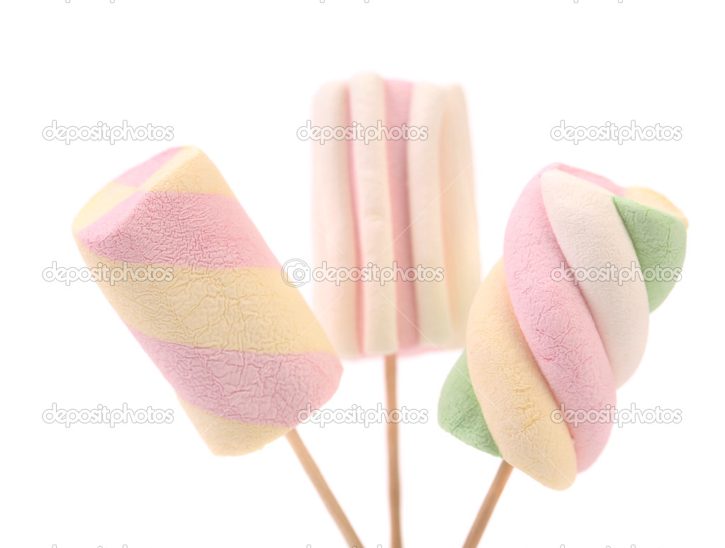 Three different colorful marshmallow on sticks.
