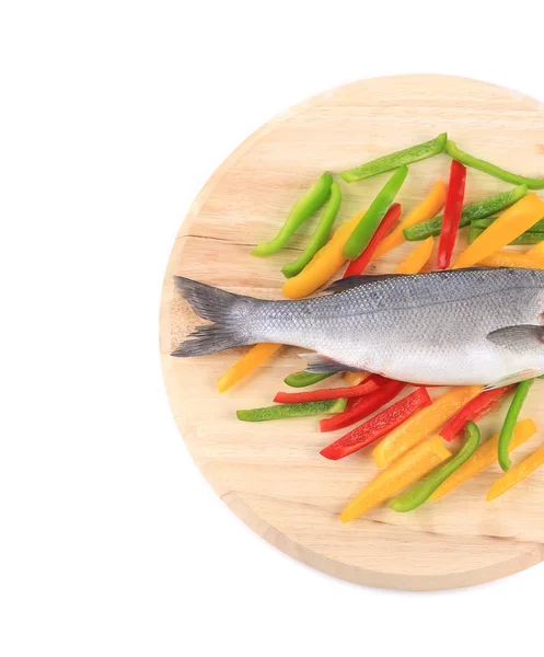Fresh seabass fish on colorful pepper. — Stock Photo, Image