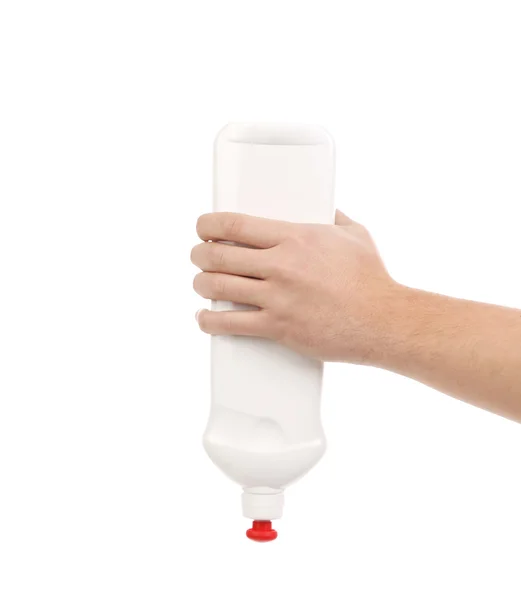 Mão segurando garrafa de plástico branco — Fotografia de Stock