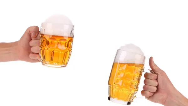 Two full beer mugs in hand — Stock Photo, Image