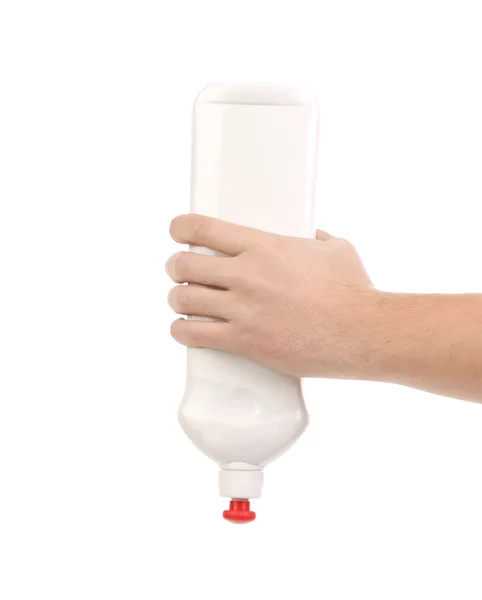 Hand holding white plastic bottle — Stock Photo, Image