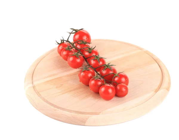 Tomatoes on wooden platter — Stock Photo, Image