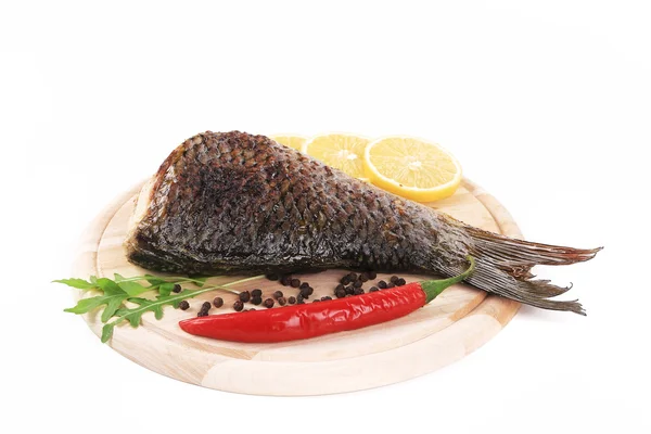 Fried carp on wooden platter — Stock Photo, Image