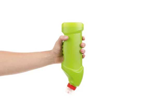 Hand hält grüne Flasche — Stockfoto