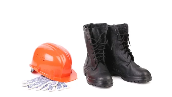 Boots and hard hat on gloves — Stock Photo, Image