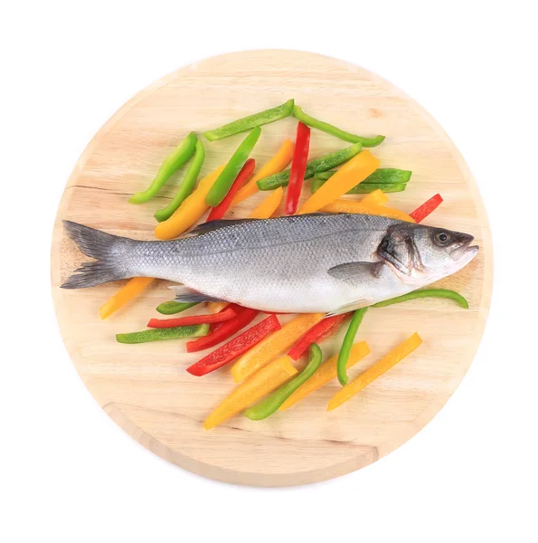 Fresh seabass fish on colorful pepper — Stock Photo, Image